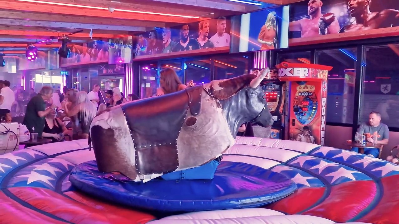 Pretty Girl in Beautiful Dress Riding on a Bull in Benidorm ...