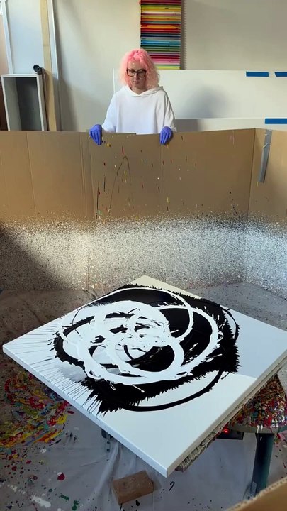 Artist is pouring fluid acrylic onto a canvas and spinning it to create art!