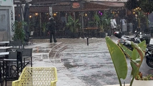 Bin glides through Santa Ponsa's flooded street during flash flood