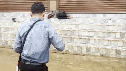 Heartfelt moment: Man tries to feed a homeless man after 'Typhoon Yagi' strikes