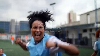 Female soccer playes celebrating celebrating a goal