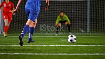SLO MO TS Female soccer player scoring a goal at a soccer match at night