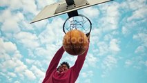 SLO MO Basketball player performs a slam dunk