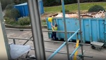 Construction worker ends up being covered in garbage while trying to clean up