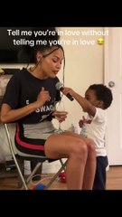 Woman is singing while toddler holds the microphone for her