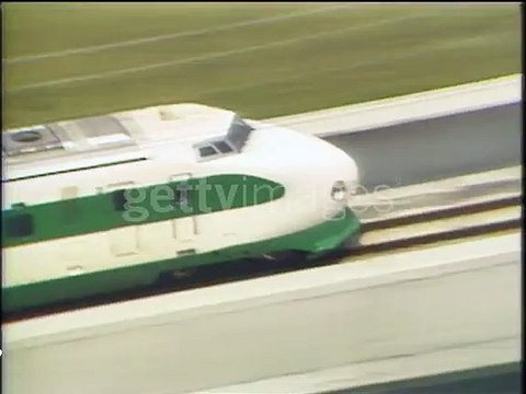 A Tohoku Shinkansen bullet train locomotive speeds through the Japanese countryside on opening day - HD stock video