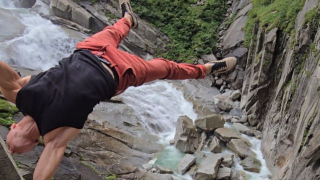Pole dancer wows with fearless air walk, balancing horizontally over scenic water