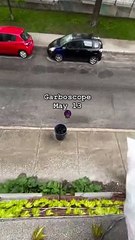 Guy throws his garbage from the second story window to the trash can below!