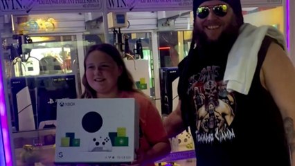Little girl wins Xbox at arcade and eagerly unboxes it at home with joy
