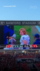 Glen Powell Films Scene During Halftime at College Football Game