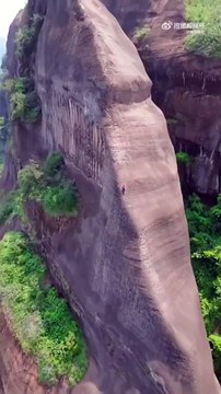 Elle escalade cette montagne en utilisant les marches et c'est vertigineux