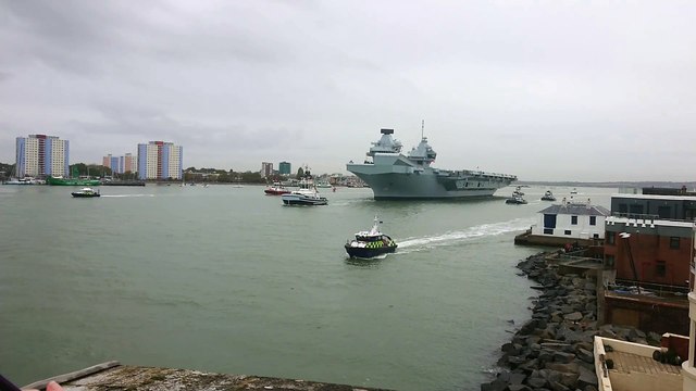 HMS Queen Elizabeth leaves Portsmouth as crowds gather to watch her depart