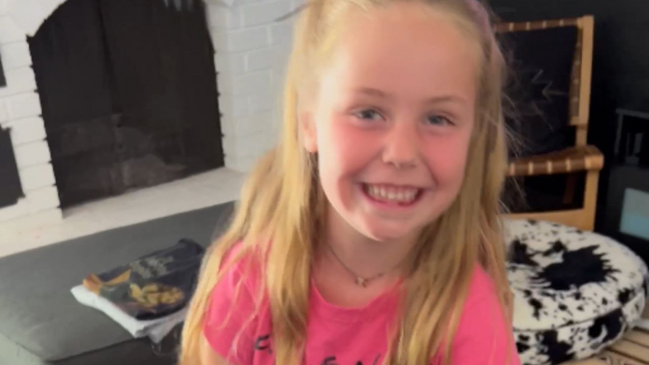 Little girl tries ruby slippers for the first time and wobbles while walking