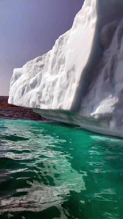 Sailing close to the impressive icebergs in turquoise blue waters in Greenland on a RIB boat