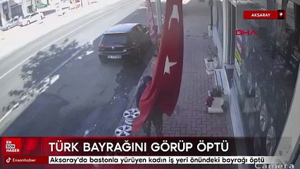Aksaray'da bastonla yürüyen kadın iş yeri önündeki bayrağı öptü