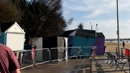 Woman and dog narrowly escaped a fallen cliff fall onto beach huts