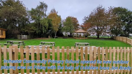 Northampton Town manager Jon Brady cuts the ribbon on Irchester Community Primary's new outdoor playing area
