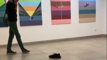 Boy mistakes a shoe for modern art and begins inspecting it from every angle