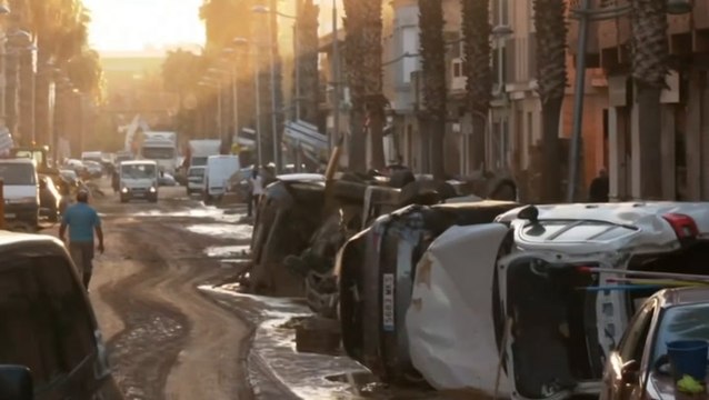 Cars and furniture lay piled up in mud as Spain reels from deadly floods