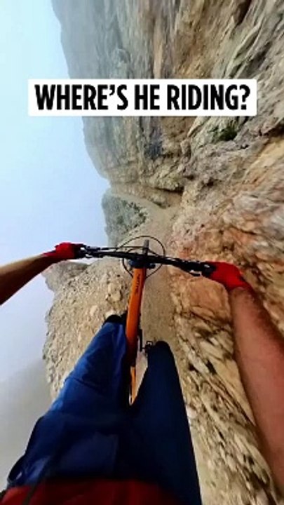 Cycle stunt over hill