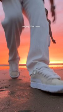 Enjoying a beautiful beach sunset together.