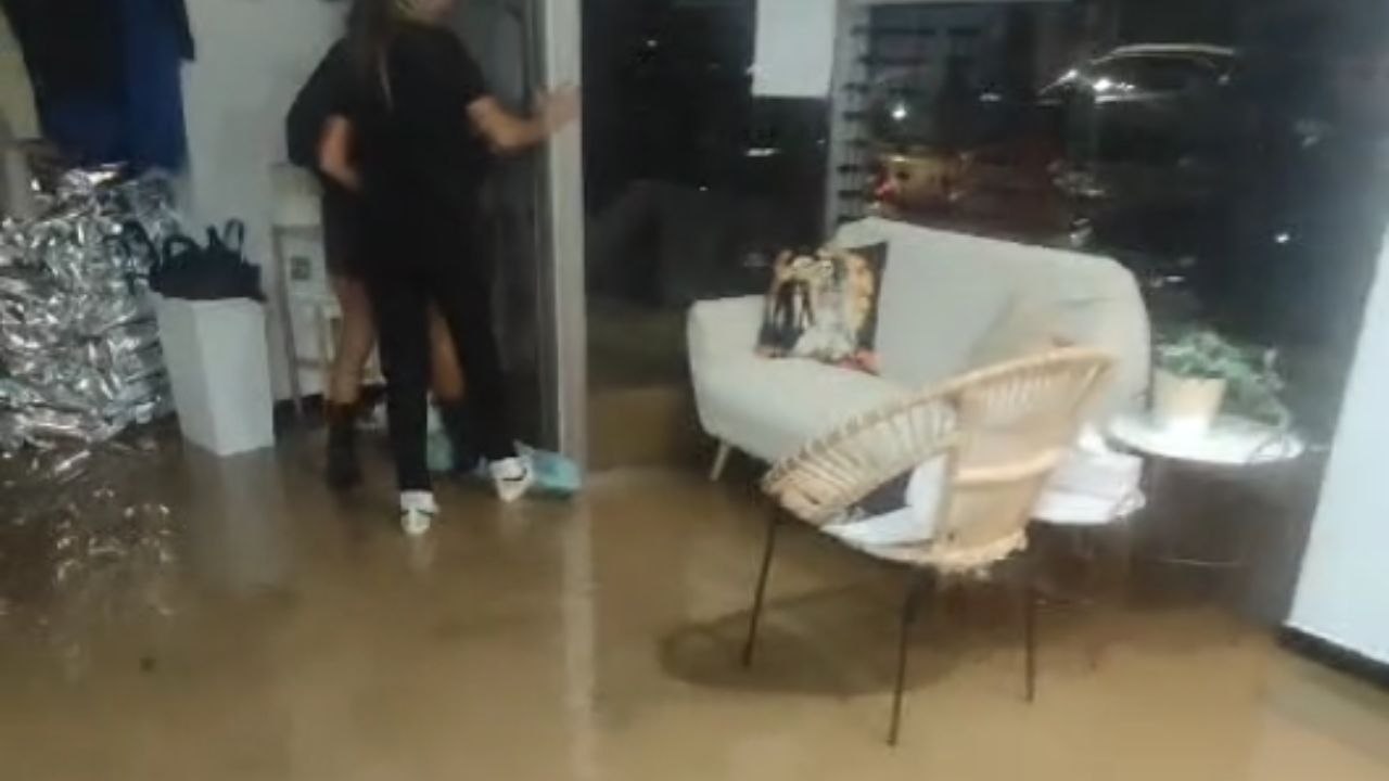 Valencia, Spain: High water pressure bursts door open, enabling people to escape during flash flood.