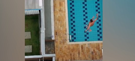 On-the-run suspect leaps from roof into swimming pool