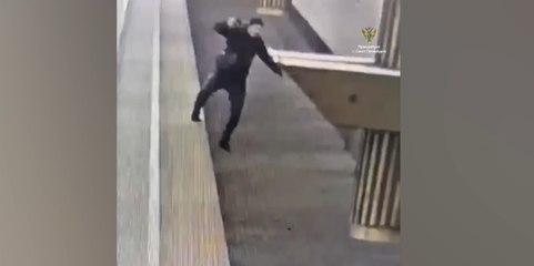 Man staring at phone falls off platform