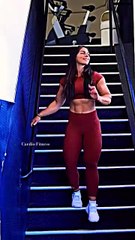 A bodybuilder girl showcasing her impressive muscles and pushing through a challenging workout.