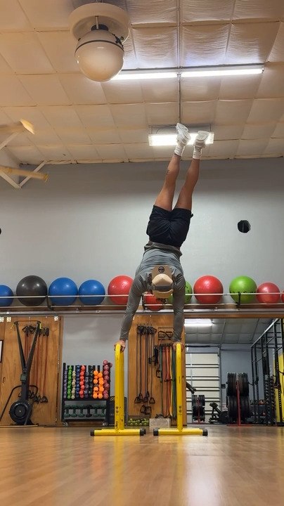 Man Attempts Handstand but Loses Balance and Falls