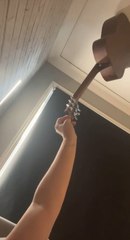 Man's epic guitar balancing act hits the roof