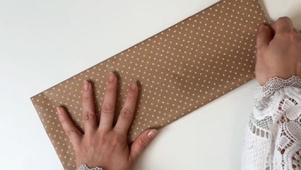Girl creates a chic gift bag with wrapping paper and folds