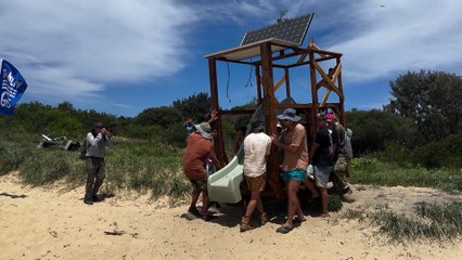 Protesters carry a pontoon onto the beach ahead of the flotilla launch in Newcastle  Newcastle Herald | November 22, 2024