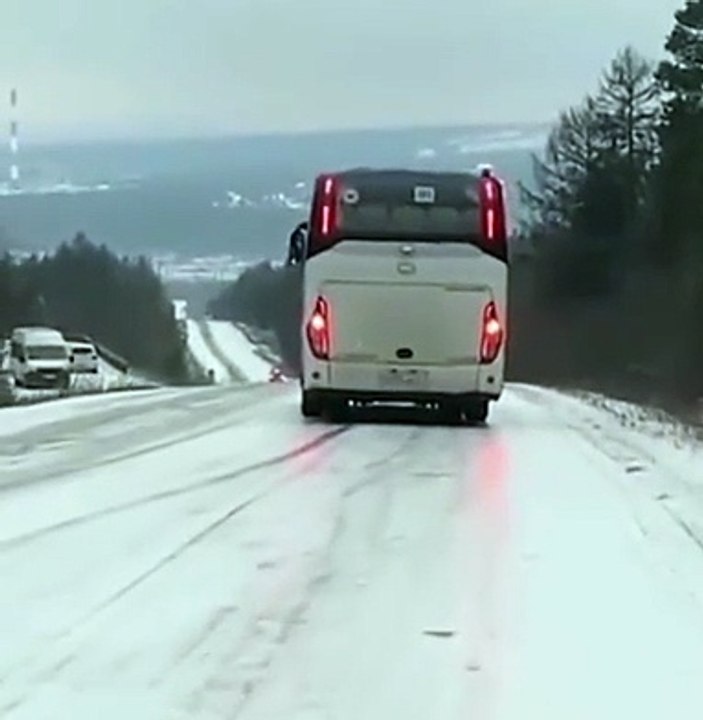 Bus sliding down icy road (video)