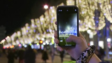 Crowds gather at Paris' Champs-Elysees for Christmas lights display