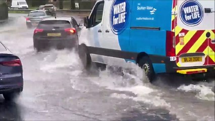 Watch as vehicles navigate heavy road flooding in Crawley