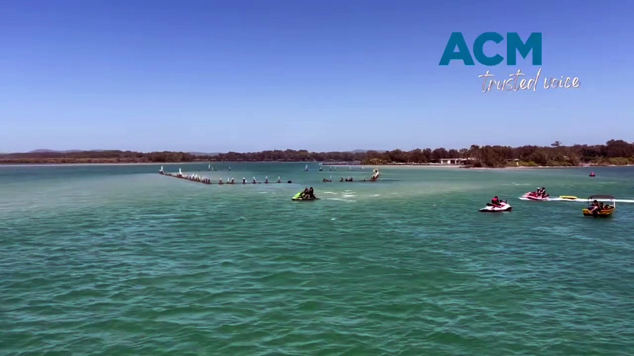 Jet skiers harass a dolphin at Forster.