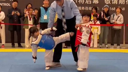 Funny children's taekwondo match as battling kids fail to kick one another