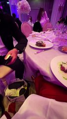 Woman uses a long fork to steal man s steak!