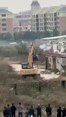 Chinese man fights off excavator that came to demolish his house with fireworks