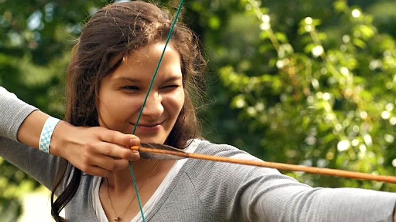 Female archer shooting an arrow - Free Stock Video