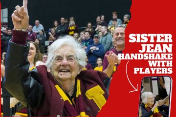 Sister Jean handshaking wiht the Loyola's baske¡tball team