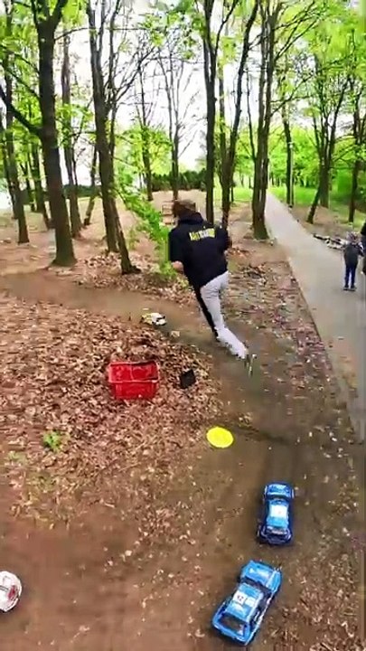 People are doing remote control Rally car races in the park!