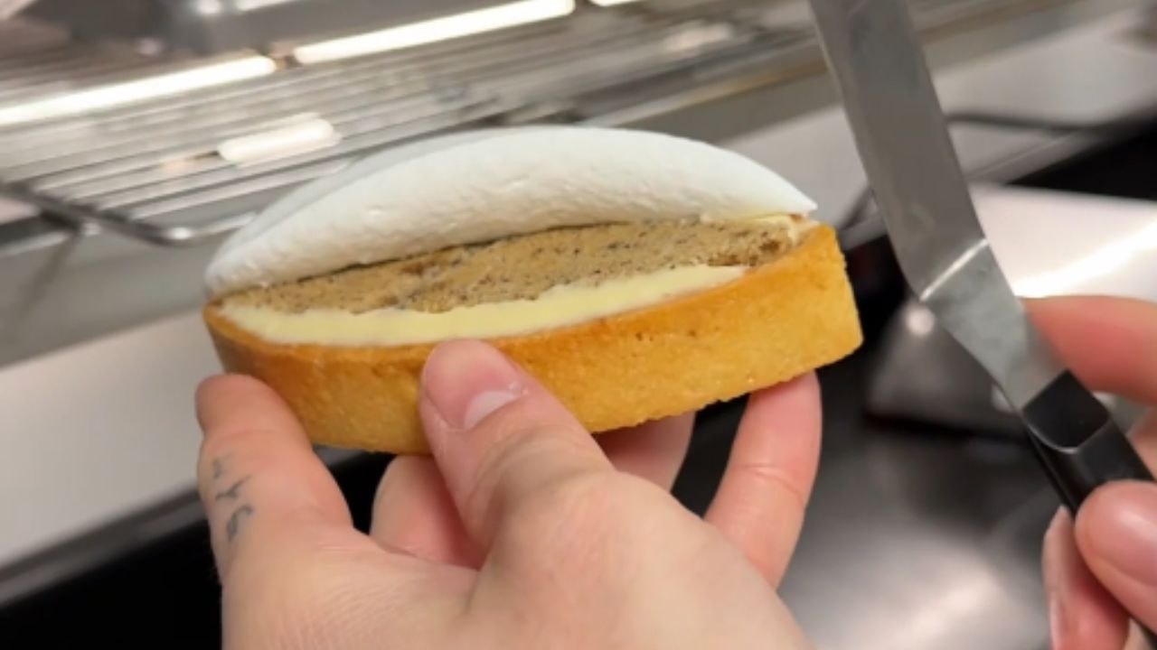 Baking master decorates a lemon pie with whipped cream like a pro