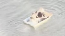 Moment alleged jewel thieves try to escape police on sinking rowboat