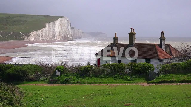 Establishing shot of the beautiful houses along the shore of the White Cliffs of Dover at Beachy Head England