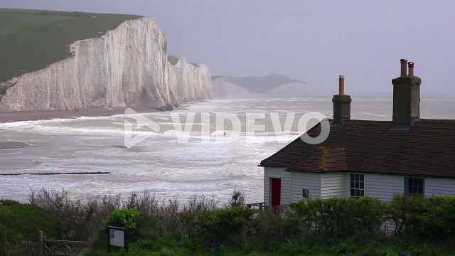 Establishing shot of the beautiful houses along the shore of the White Cliffs of Dover at Beachy Head England 1