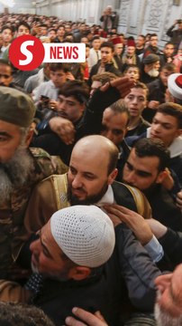 Syria's new caretaker PM arrives at Umayyad Mosque for Friday prayers