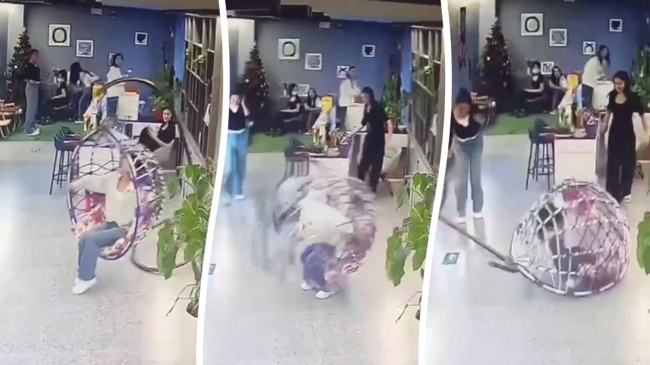 Frau fällt von hängendem Eierstuhl und wird darunter eingeklemmt