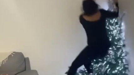 Christmas tree mishap: Girl crashes into Christmas tree and falls in the corner